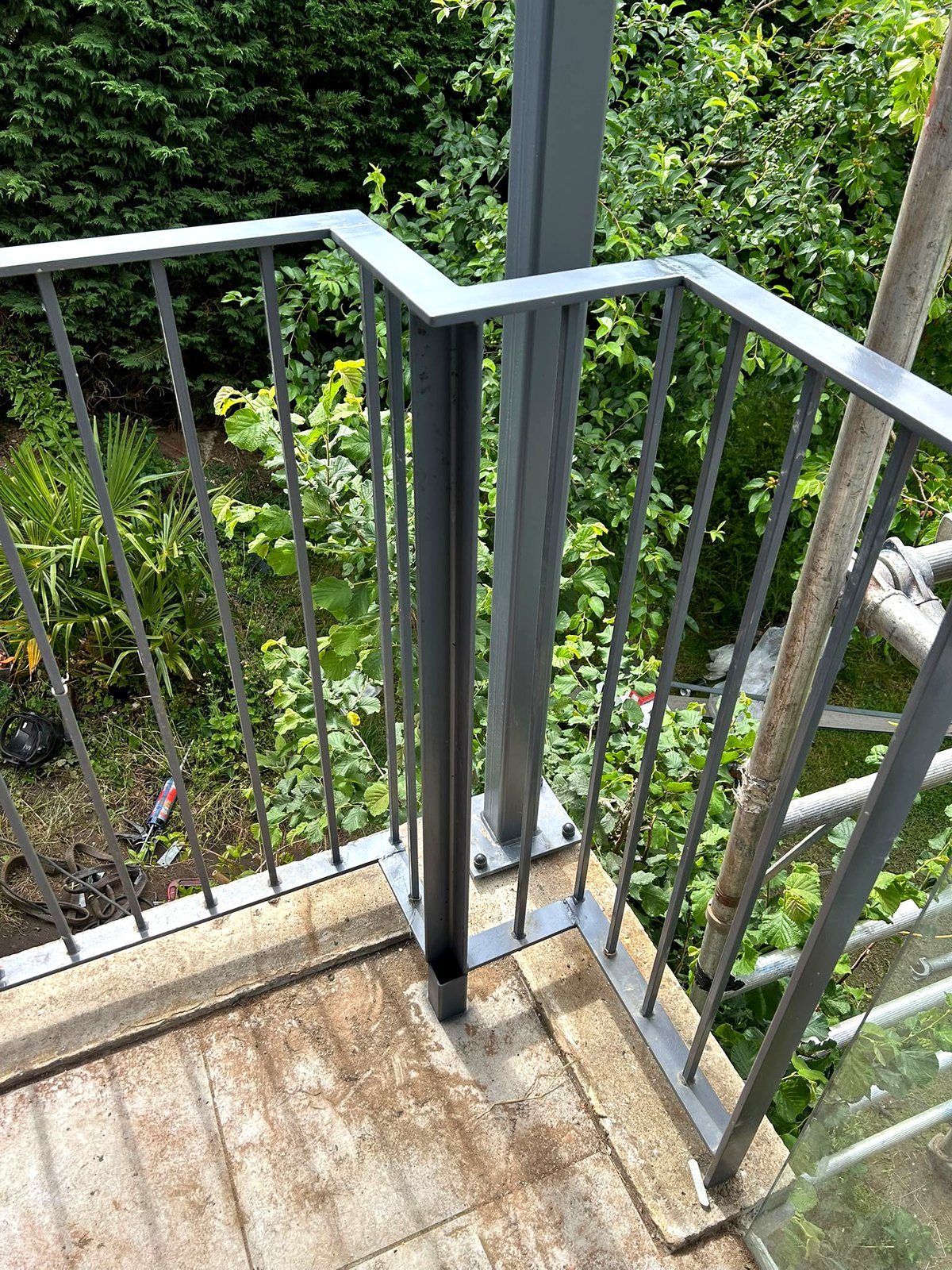 Grey powder-coated steel staircase with square-bar balustrade down to the garden, Bourne End
